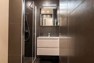 a bathroom with a sink and a mirror at Cozy 1-Br Apartment heart of Palm Beach district in Cannes