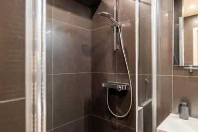 a bathroom with a shower and a sink at Cozy 1-Br Apartment heart of Palm Beach district in Cannes