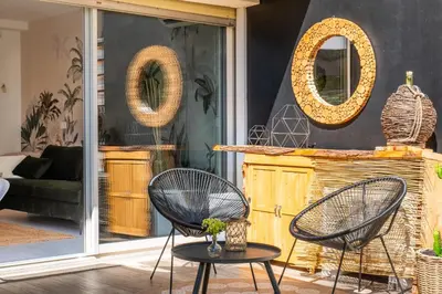 a living room with two chairs and a table at Cozy 1-Br Apartment heart of Palm Beach district in Cannes