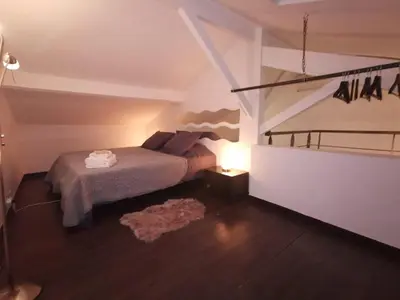 a small bedroom with a bed and a lamp at Duplex 3 pièces 4 couchages au Suquet à 2 mn à pied du port de Cannes, du centre, de la mer et du palais des festival in Cannes