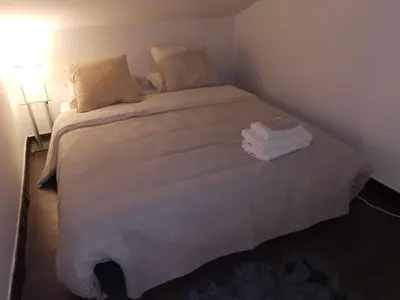a bedroom with a large bed with towels on it at Duplex 3 pièces 4 couchages au Suquet à 2 mn à pied du port de Cannes, du centre, de la mer et du palais des festival in Cannes