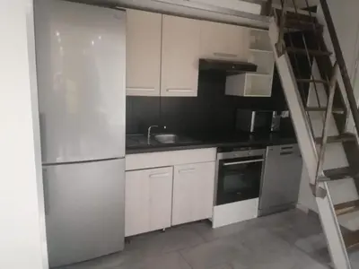 a kitchen with white cabinets and a ladder in it at Duplex 3 pièces 4 couchages au Suquet à 2 mn à pied du port de Cannes, du centre, de la mer et du palais des festival in Cannes