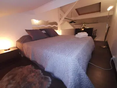 a bedroom with a large bed in a room at Duplex 3 pièces 4 couchages au Suquet à 2 mn à pied du port de Cannes, du centre, de la mer et du palais des festival in Cannes