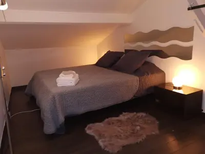 a bedroom with a bed with a pile of towels on it at Duplex 3 pièces 4 couchages au Suquet à 2 mn à pied du port de Cannes, du centre, de la mer et du palais des festival in Cannes
