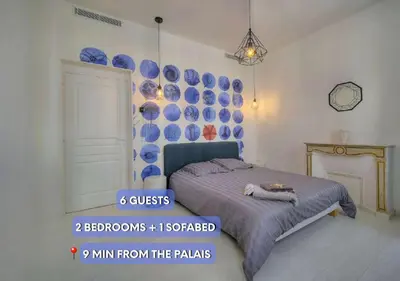 a bedroom with a bed and blue plates on the wall at Superb 2 Bedrooms, 1 sofabed 3P1 by RIVAEVENT in Cannes