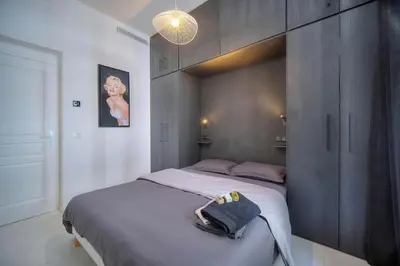 a bedroom with a large bed in a room at Superb 2 Bedrooms, 1 sofabed 3P1 by RIVAEVENT in Cannes