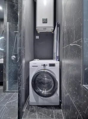 a washer and dryer in a small bathroom at Superb 2 Bedrooms, 1 sofabed 3P1 by RIVAEVENT in Cannes