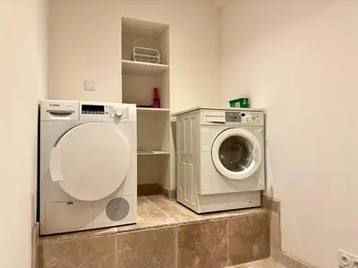 a laundry room with a washer and a washing machine at Eleganza By SCLS Locations in Cannes