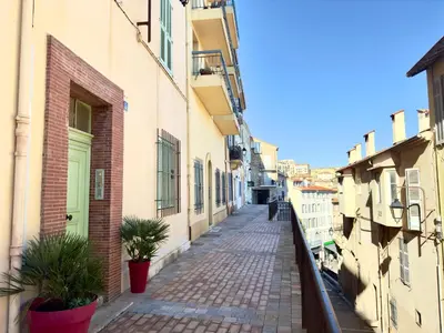 an alley in a city with buildings and plants at Eleganza By SCLS Locations in Cannes