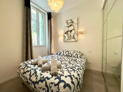 a bedroom with a bed with towels on it at Eleganza By SCLS Locations in Cannes