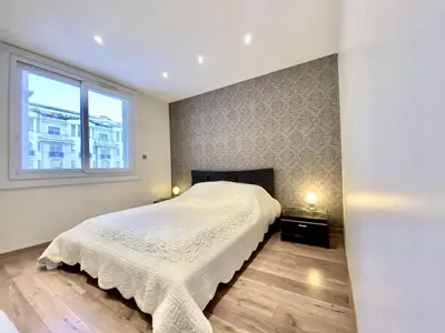 a bedroom with a large bed and a window at HENRY IV 2 pieces MES1112 in Cannes