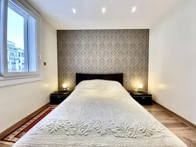 a bedroom with a large bed with two night stands at HENRY IV 2 pieces MES1112 in Cannes
