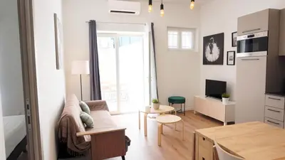 a living room with a couch and a table at Centre Cannes, Le Grand Turkheim By Palmazur Vacances in Cannes
