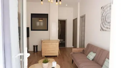 a living room with a couch and a table at Centre Cannes, Le Grand Turkheim By Palmazur Vacances in Cannes