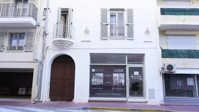 a white building with a door and a window at Centre Cannes, Le Grand Turkheim By Palmazur Vacances in Cannes