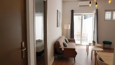 a living room with a couch and a bedroom at Centre Cannes, Le Grand Turkheim By Palmazur Vacances in Cannes