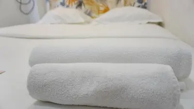 a row of white towels sitting on top of a bed at Proche Carlton & Croisette, Appartement 302 - Palmazur Vacances in Cannes