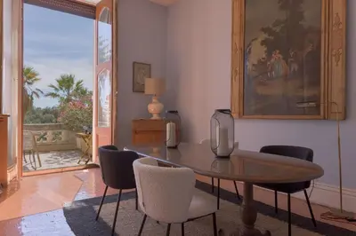 a dining room with a table and some chairs at Le Château Vallombrosa by Halldis in Cannes
