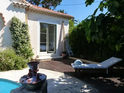a house with a pool and a chair in front of it at Blue Dream Cannes Guest House in Cannes