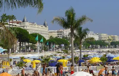 a beach with many umbrellas and a crowd of people at Blue Dream Cannes Guest House in Cannes
