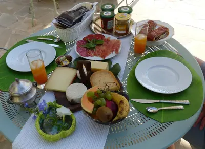 a table with plates of food on top of it at Blue Dream Cannes Guest House in Cannes