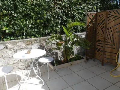 two tables and chairs sitting on a patio at Blue Dream Cannes Guest House in Cannes