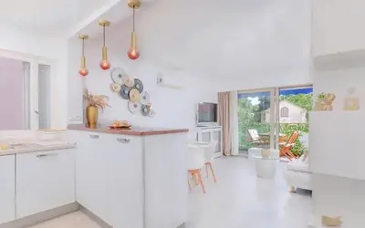 a kitchen with white walls and white appliances at Le Concorde - Charmant appt avec terrasse in Cannes