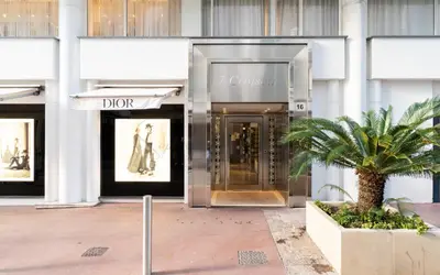 a front door of a building with a palm tree in front at PLEIN SUD - le tapis rouge Croisette in Cannes