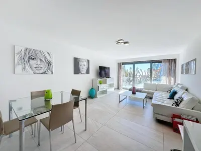 a living room with a couch and a table at PLEIN SUD - le tapis rouge Croisette in Cannes