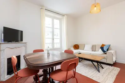 a living room with a table and a couch at Villa CANA in Cannes