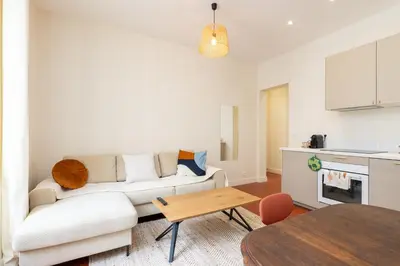 a living room with a white couch and a table at Villa CANA in Cannes