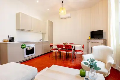 a kitchen and a living room with a table and chairs at Villa CANA in Cannes