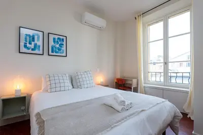 a bedroom with a white bed with two towels on it at Villa CANA in Cannes