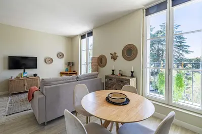 a living room with a couch and a table and chairs at Quiet and luxurious studio - Cannes Center in Cannes