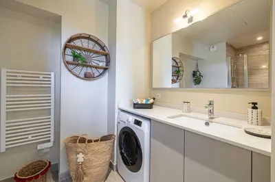 a laundry room with a washing machine and a sink at Quiet and luxurious studio - Cannes Center in Cannes