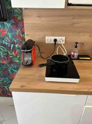 a pot sitting on top of a stove on a counter at Tapualiki studio cosy tout confort in Cannes