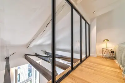 a staircase in a room with large windows at Appartement Croisette Cannes centre in Cannes