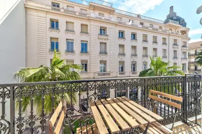 a wooden bench sitting in front of a building at Appartement Croisette Cannes centre in Cannes