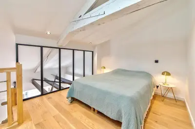 a bedroom with a bed and a large window at Appartement Croisette Cannes centre in Cannes