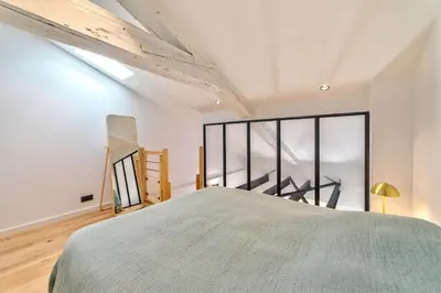 a bedroom with a bed and a large window at Appartement Croisette Cannes centre in Cannes
