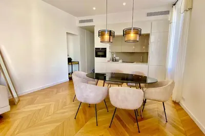 a dining room with a black table and chairs at KEEP IN TOUCH 3 BEDROOM/3 BATHROOM/WIFI in Cannes