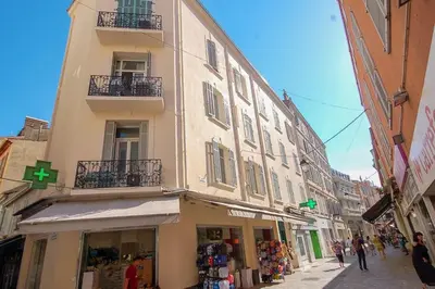 a building with a green cross on it on a street at KEEP IN TOUCH 3 BEDROOM/3 BATHROOM/WIFI in Cannes