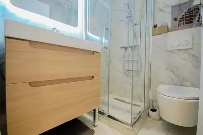 a bathroom with a shower and a sink and a toilet at KEEP IN TOUCH 3 BEDROOM/3 BATHROOM/WIFI in Cannes