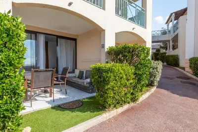 a house with a table and chairs in a yard at Appartement Wemyssia - Welkeys in Cannes
