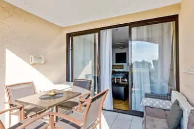 a dining room with a table and chairs at Appartement Wemyssia - Welkeys in Cannes