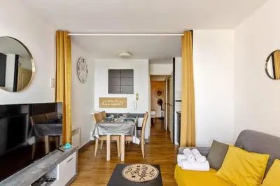 a living room with a couch and a table at Appartement Wemyssia - Welkeys in Cannes