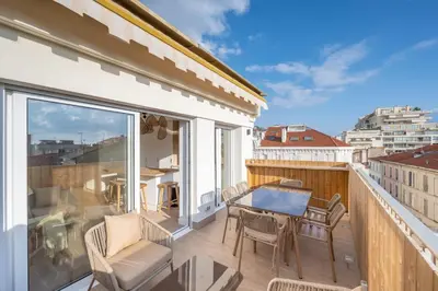 a balcony with a table and chairs at Beautiful flat with terrace - Carre d'Or Cannes in Cannes
