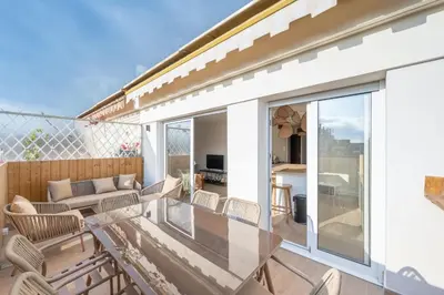 a balcony with chairs and a couch on a building at Beautiful flat with terrace - Carre d'Or Cannes in Cannes