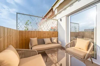 a balcony with two chairs and a couch at Beautiful flat with terrace - Carre d'Or Cannes in Cannes