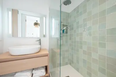 a bathroom with a sink and a glass shower at Beautiful flat with terrace - Carre d'Or Cannes in Cannes